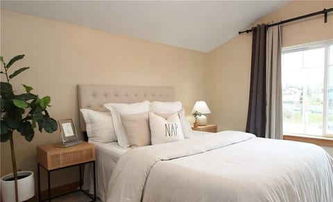 Bright, cozy bedroom with plush linens, natural light, and serene style
