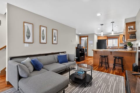 Bright open living space with cozy sectional and breakfast bar seating