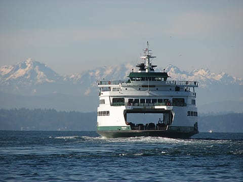 Scenic ferry views with mountain backdrop and coastal charm