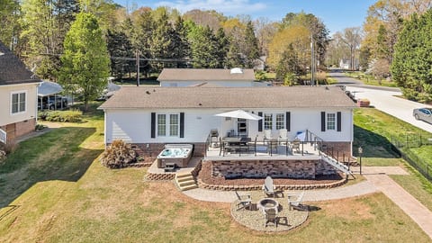 Relax on the spacious deck with outdoor dining, grill, and seating, then unwind in the private hot tub. Gather around the firepit below or follow the short path down to your private boat dock for easy lake access and scenic views.