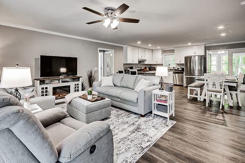 Open concept makes spending time together enjoyable. Living room with Roku TV, DVDs, Books, and electric fireplace for cozy nights.