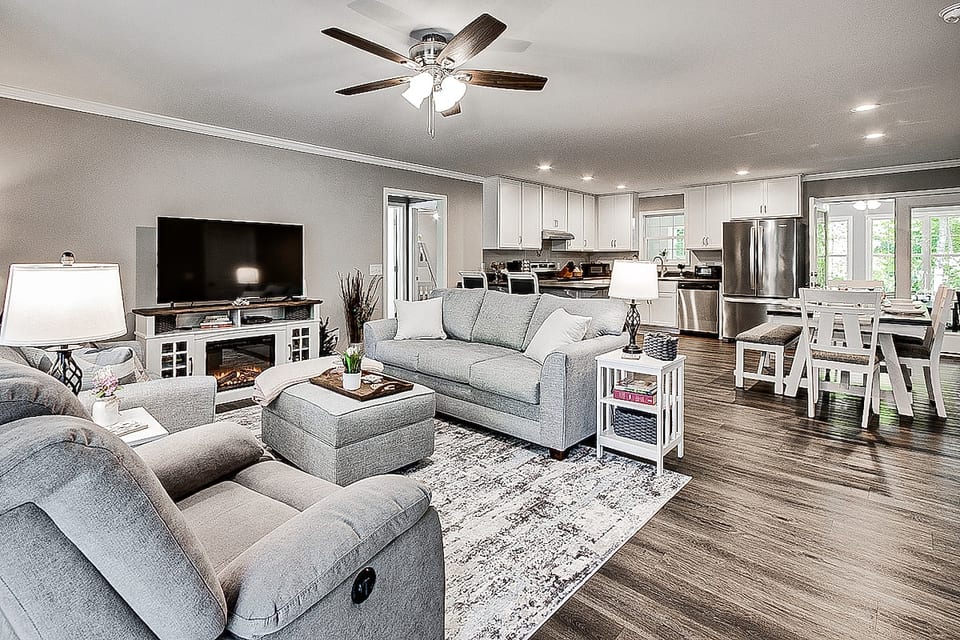 Open concept makes spending time together enjoyable. Living room with Roku TV, DVDs, Books, and electric fireplace for cozy nights.