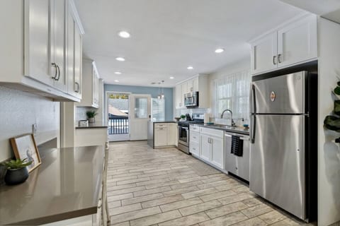 Open kitchen with tons of natural light. Fully stocked to simply show up and enjoy your vacation.