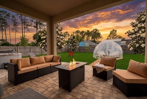 Gather around the fire pit under a covered patio built for unforgettable nights. Plush sectional seating, warm flames, and a sunset backdrop — this is where memories are made.