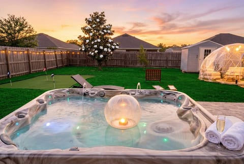 Tee off under the twinkle lights then retreat to your cozy dome — this backyard does it all. A private putting green and glamping bubble pod make every evening feel like a five-star staycation