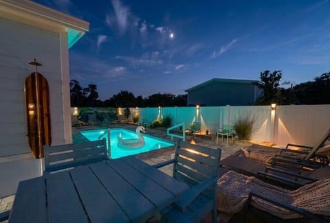 Private lit pool oasis with lounge seating for dreamy evening swims
