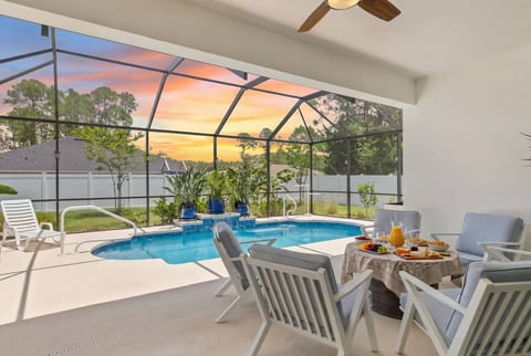 Screened pool lanai with outdoor dining — the perfect Florida al fresco experience at Salty Reef vacation rental