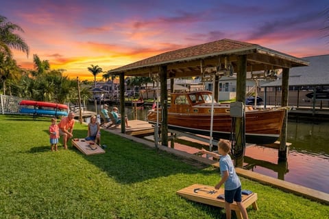Waterfront lawn, private dock, and sunset fun by the canal