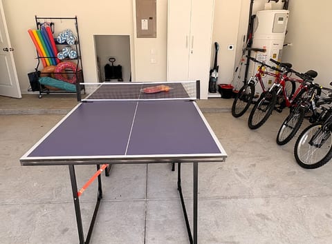 Game-ready garage with ping pong, bikes, and beach gear for guest fun