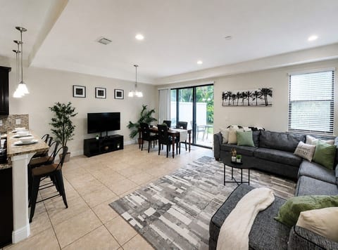 Living Room – Bright, open living room with comfortable seating and Smart TV.