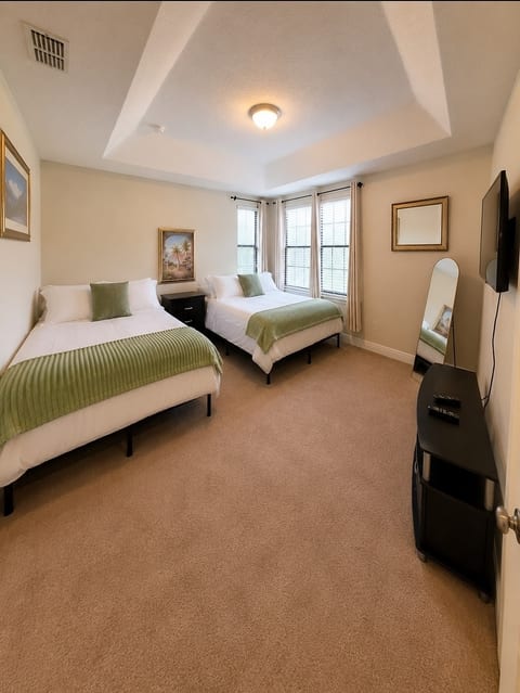 Primary Suite 2. Two queen beds and ensuite bath.