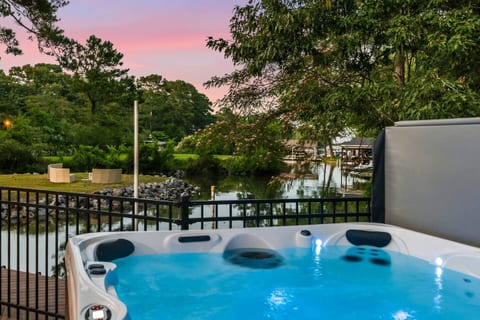 Serene hot tub with waterfront views