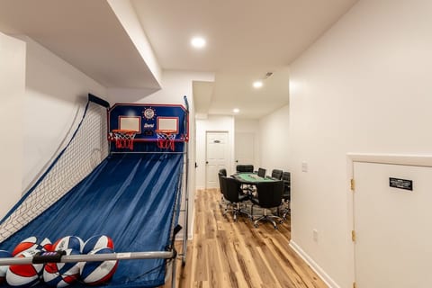 Game room fun with arcade basketball and poker table seating