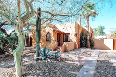 Front Entrance of adobe style home, desert landscaping.