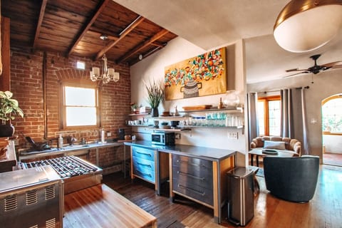 Kitchen: exposed brick, gas range, fully stocked, original wood floors