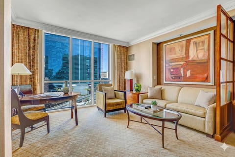 Strip-Adjacent Suite — Separate Living Area with Queen Sleeper Sofa, Dedicated Workspace, Floor-to-Ceiling Strip Views