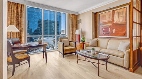 Strip-Adjacent Suite — Separate Living Area with Queen Sleeper Sofa, Dedicated Workspace, Floor-to-Ceiling Strip Views