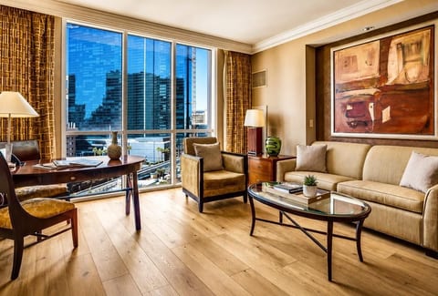 Strip-Adjacent Suite — Separate Living Area with Queen Sleeper Sofa, Dedicated Workspace, Floor-to-Ceiling Strip Views