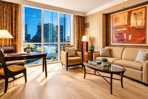 Strip-Adjacent Suite — Separate Living Area with Queen Sleeper Sofa, Dedicated Workspace, Floor-to-Ceiling Strip Views