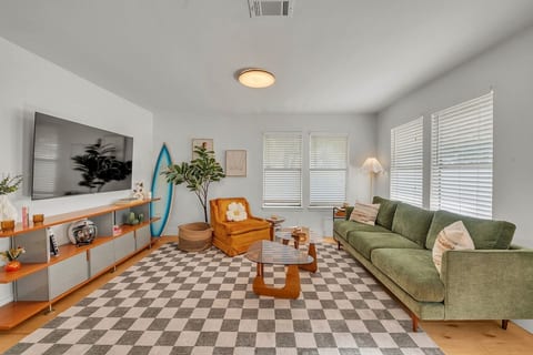 Colorful + cozy living room with retro textures and local Austin art.