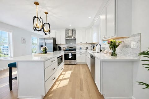 Fully equipped modern kitchen with stainless steel appliances and a spacious island—perfect for cooking or gathering.