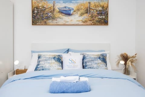 Settle into a clean and inviting bedroom with fresh linens, soft blue tones and everything you need for a comfortable night’s rest