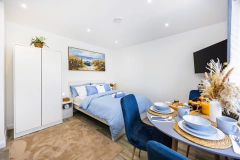 Your home away from home: Serene and spacious studio with a comfortable bed, dining area, Smart TV and plenty of natural light