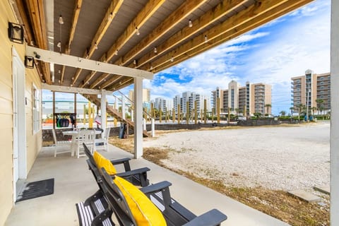 Shaded patio with string lights, near beach and skyline views