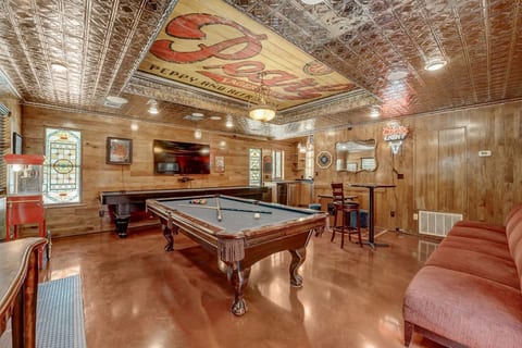 Vintage game room: pool table, bar, big TV, tin ceiling & popcorn