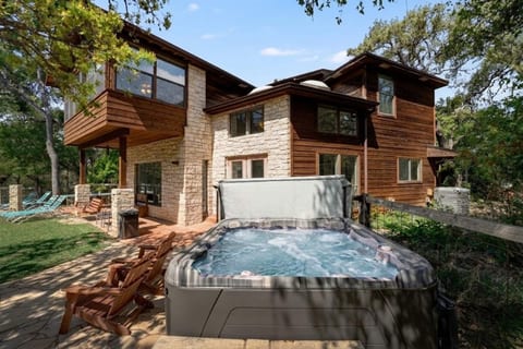Wood-and-stone retreat with private hot tub, patio & forest views