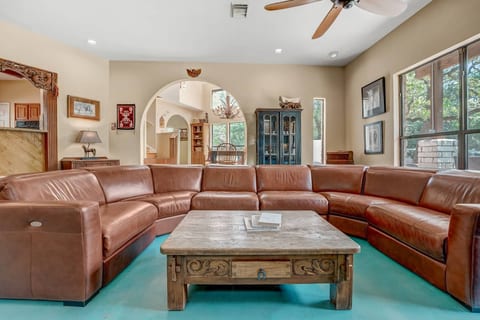 Spacious lounge with leather sectional, rustic charm & bright views