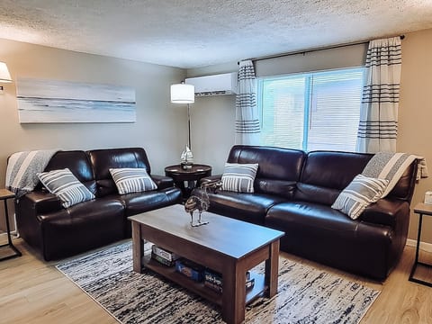 Escape the noise to recharge, the family room invites relaxation with its comfortable reclining couch, perfect for snuggling up with a throw blanket to watch a preferred movie on Roku TV, or for a lively board game challenge.
