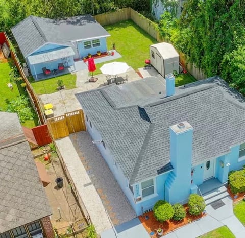 Private guest house behind the main home, with gated walkway access and outdoor space.
