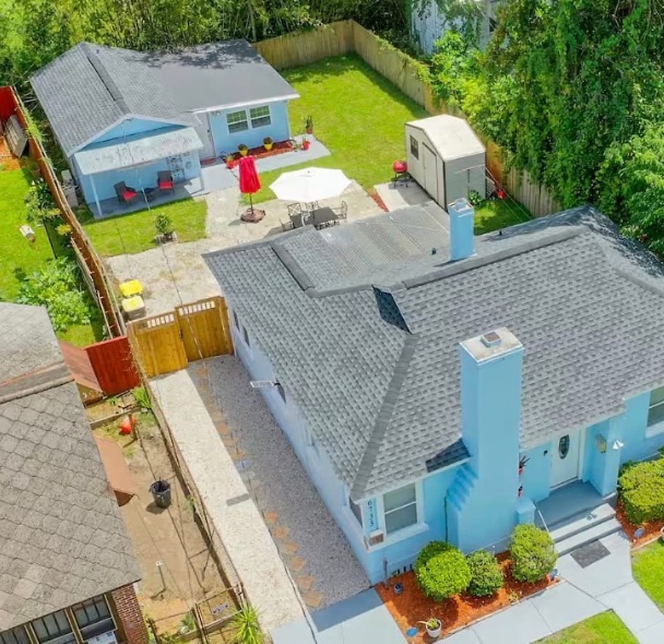 Private guest house behind the main home, with gated walkway access and outdoor space.