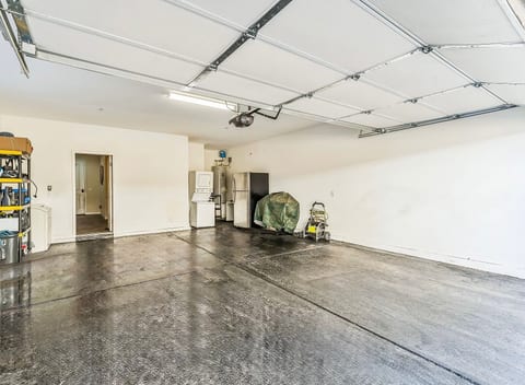 Spacious two-car garage with washer/dryer and extra fridge