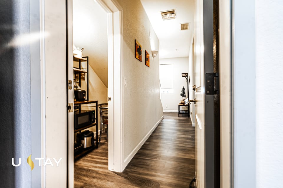 Bright modern entry hall with wood floors and convenient kitchenette nook