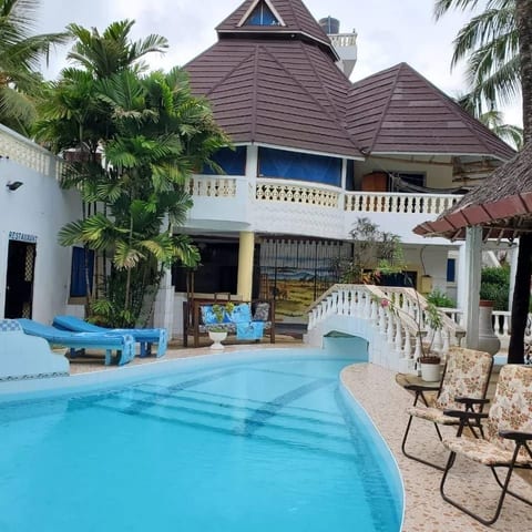 Beautiful exterior of the villa featuringa crystal clear swimming pool