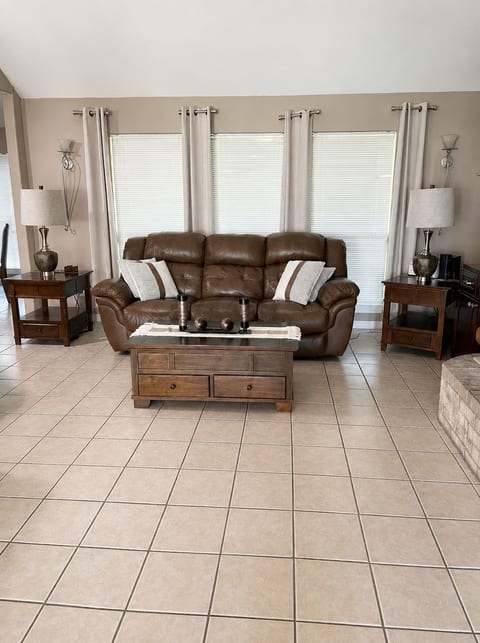 Comfortable living room with plenty of seating and natural lighting.
