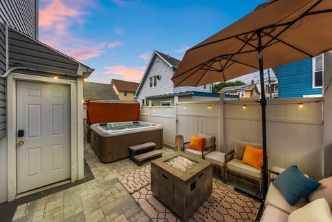 Private patio with hot tub, fire table, and cozy sunset seating