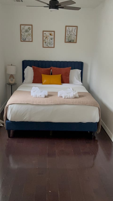 Cozy queen bedroom with stylish decor, crisp linens, and modern touches