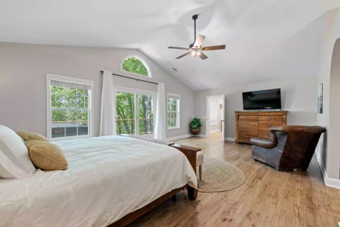 Oversized master suite with smart TV and access to the deck and hot tub