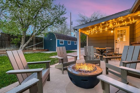 Backyard patio w/ fire pit, tree swing, yard games and lots of seating!