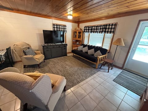 Living Room- Smart TV and a futon with a full bed