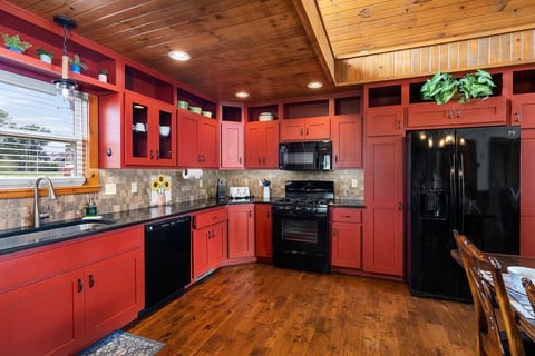 Fully equipped kitchen includes refrigerator with ice maker, gas range, microwave, dishwasher, and garbage disposal.
