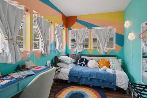 Bright, versatile bonus room filled with natural light. Relax on the cozy twin daybed with blackout curtains or get work done at the desk. Includes a luggage rack and clothes hanger for a comfortable, functional stay.