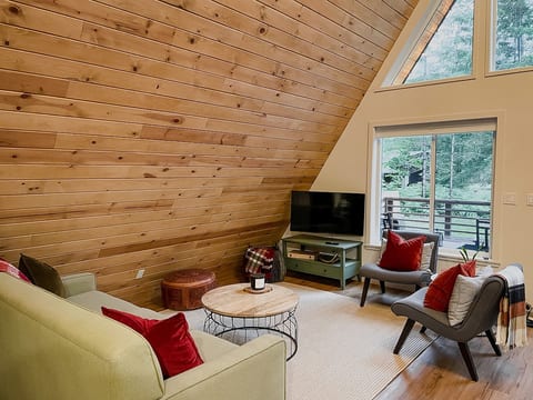 The main level boasts a cozy living area complete with a plush sofa, armchairs, and a smart TV so you can access all your favorite streaming services.