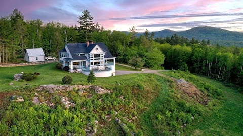 Aerial view of sunset over the house and grounds.