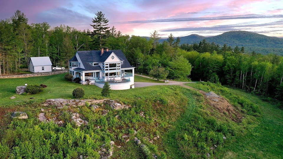Aerial view of sunset over the house and grounds.