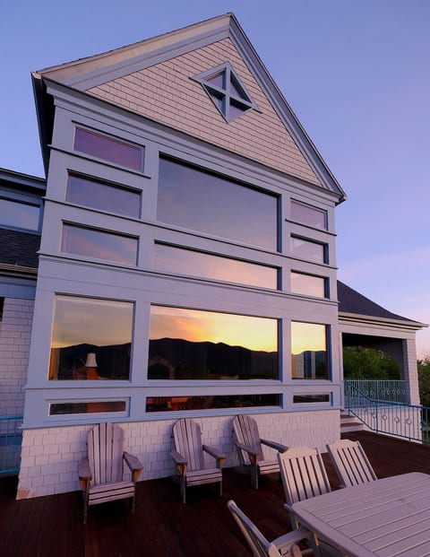 Radial deck with outdoor dining for six and Adirondack chairs.