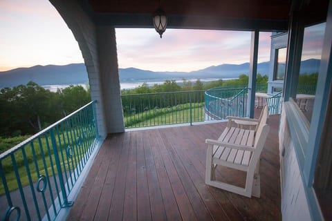 Side porch with swing seat and side table. Morning mountain views with valley fog.